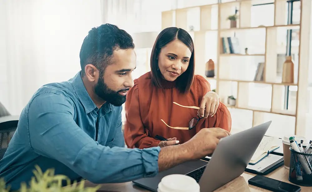 Coworking, couple in office and working together for planning remote work startup strategy online.